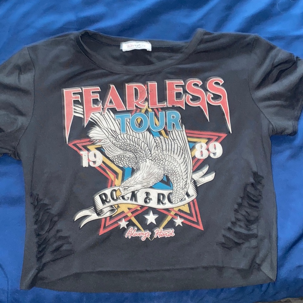 This is a crop top, with rips on the sides and font on the front.